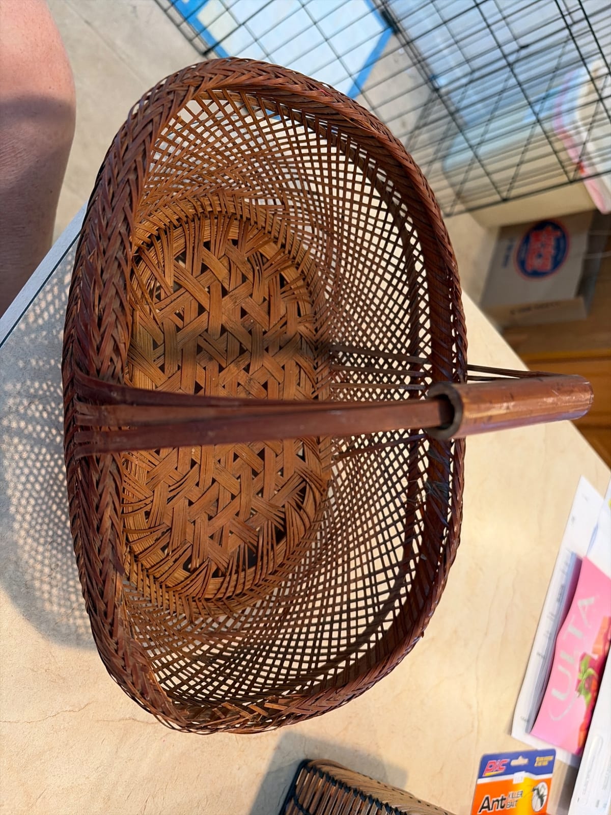 Handwoven bamboo or rattan basket/tray with central handle