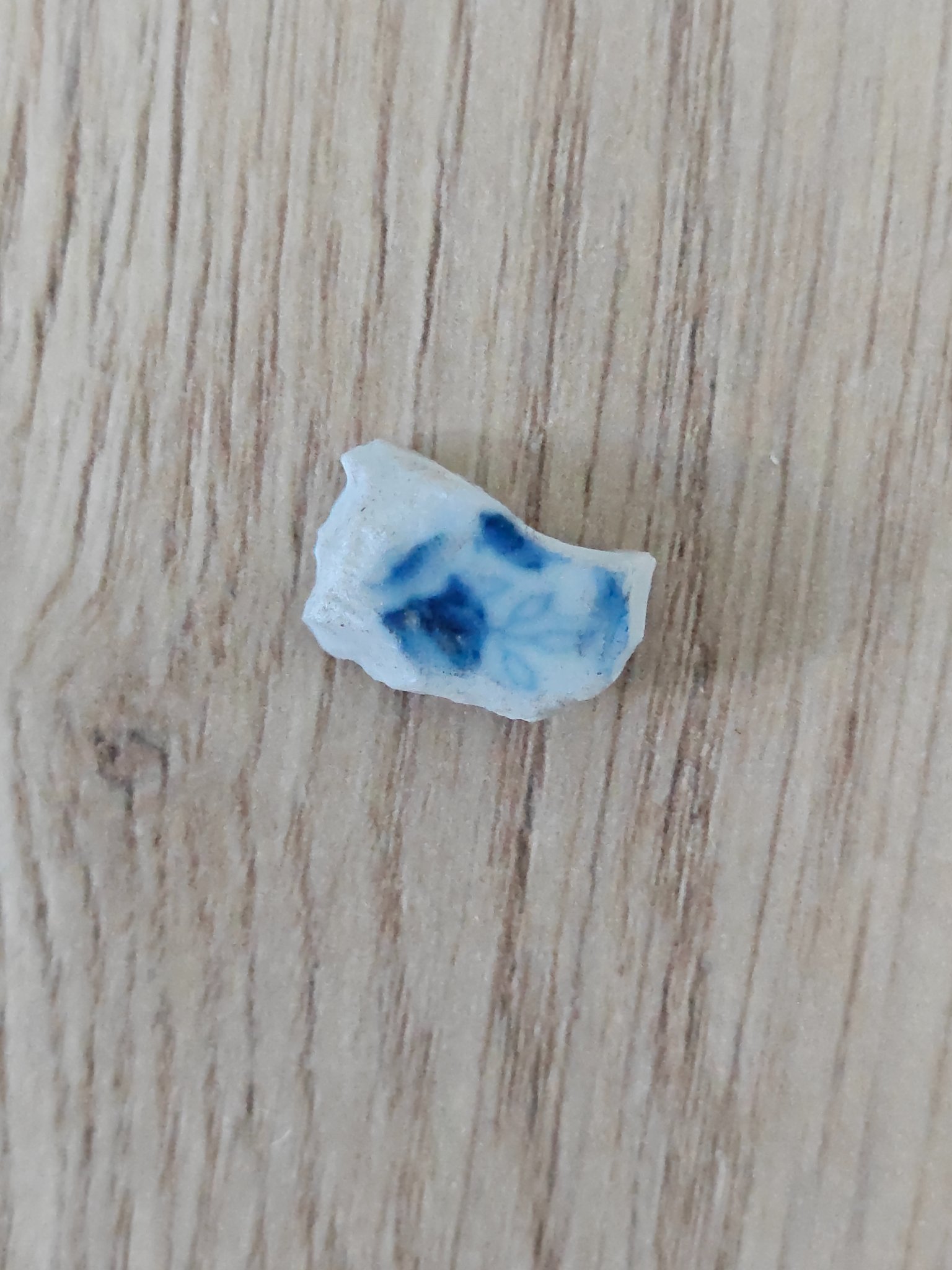 Small blue-and-white ceramic shard or porcelain fragment