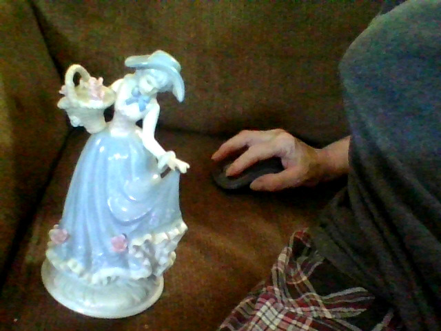 Decorative porcelain figurine of a lady with basket
