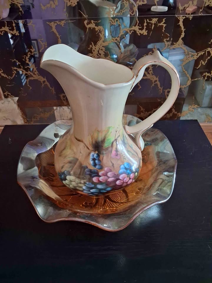 Hand-painted ceramic pitcher with matching decorative underplate