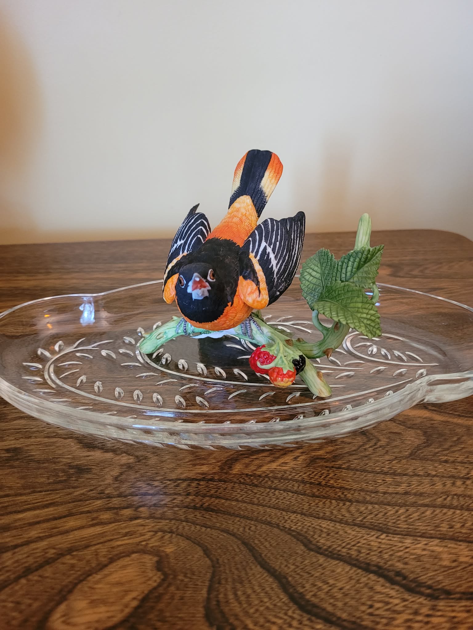 Decorative bird figurine on etched glass display plate