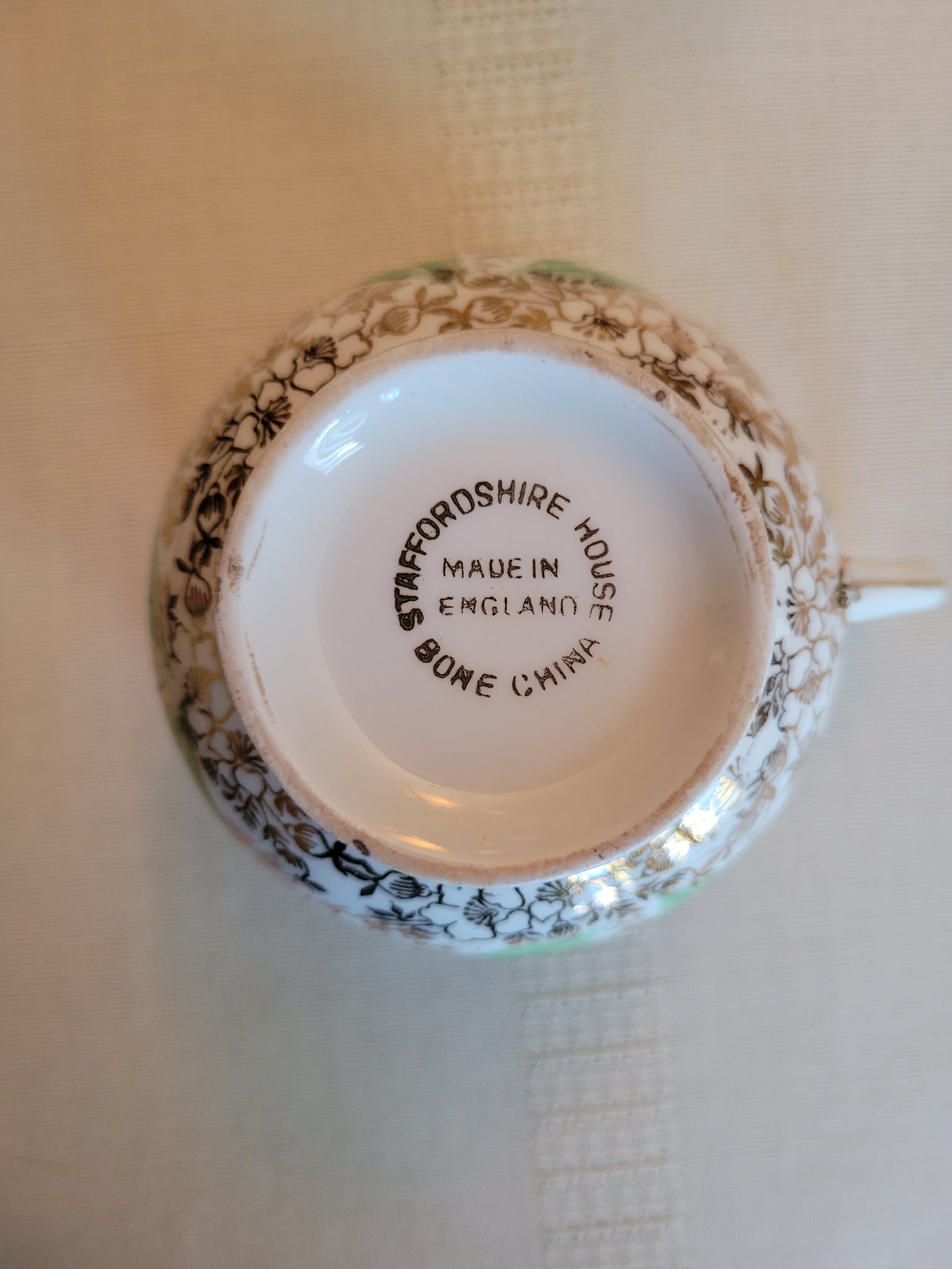 Staffordshire House bone china teacup/saucer set (visible base of cup)