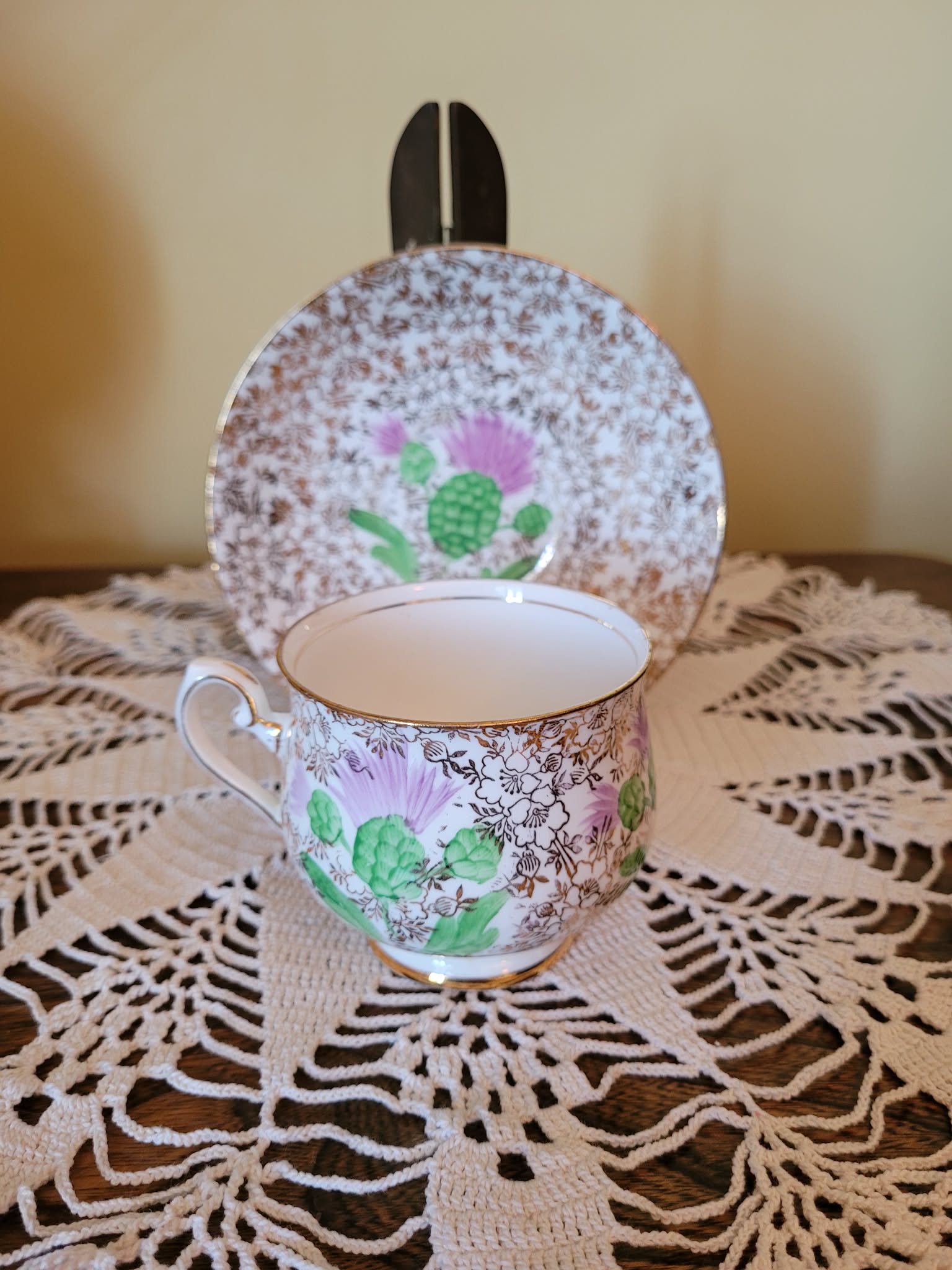 Porcelain cup and matching plate/saucer with floral and gilt decoration