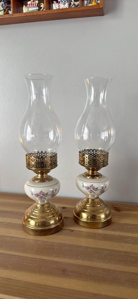 Pair of Victorian-style oil lamps with porcelain bases and brass fittings