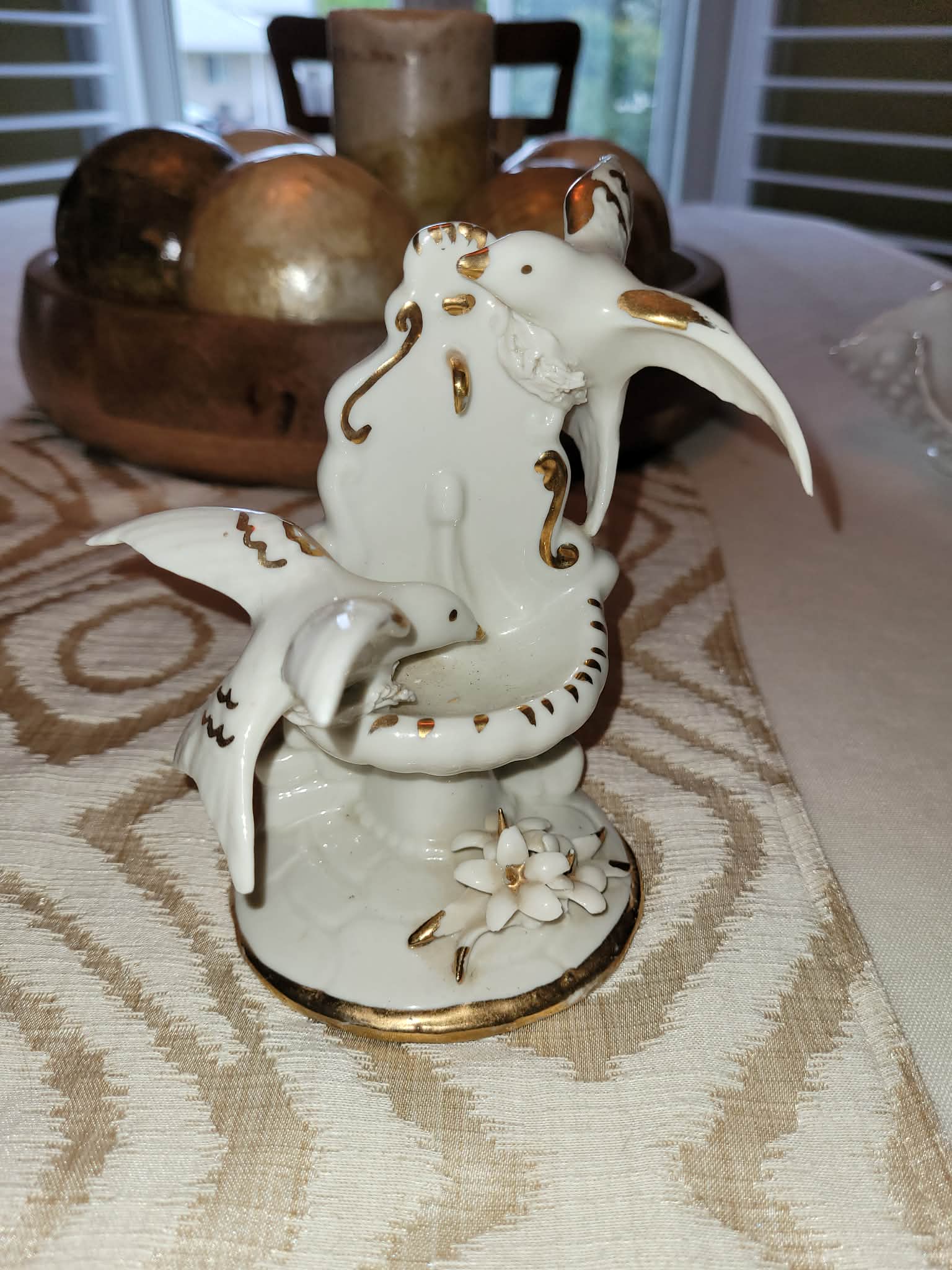 Porcelain bird figurine with floral decoration