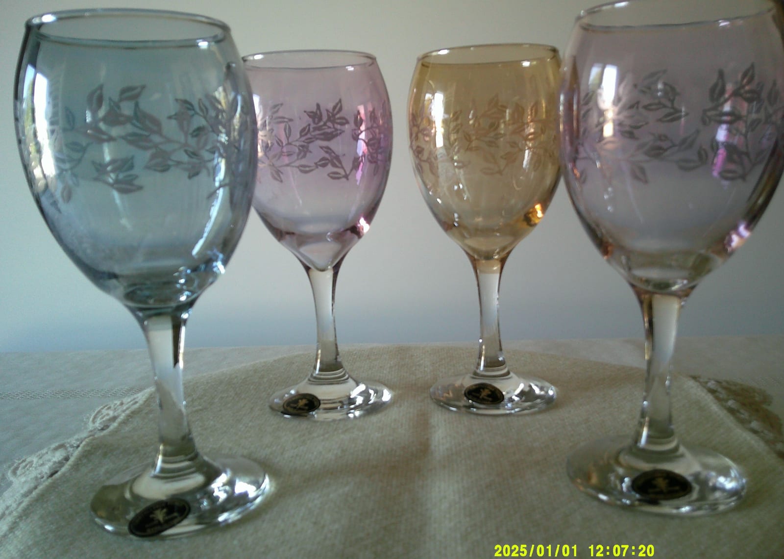 Set of etched colored stemmed wine glasses