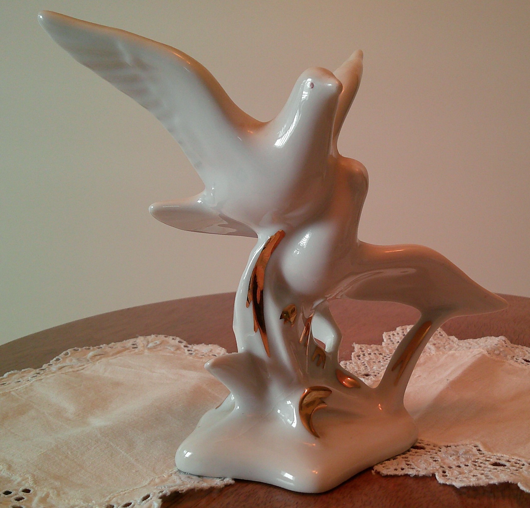 Ceramic bird figurine with gold accent decoration