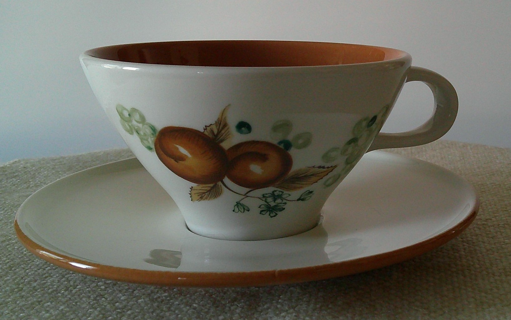 Ceramic teacup and saucer set with fruit motif