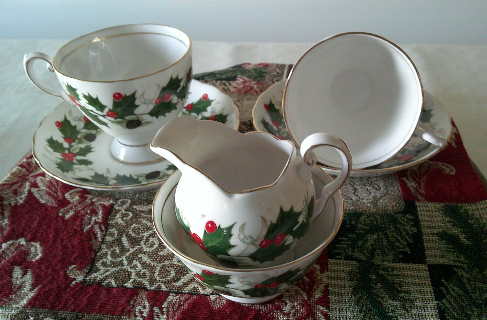 Porcelain tea service set with holly and berry decoration