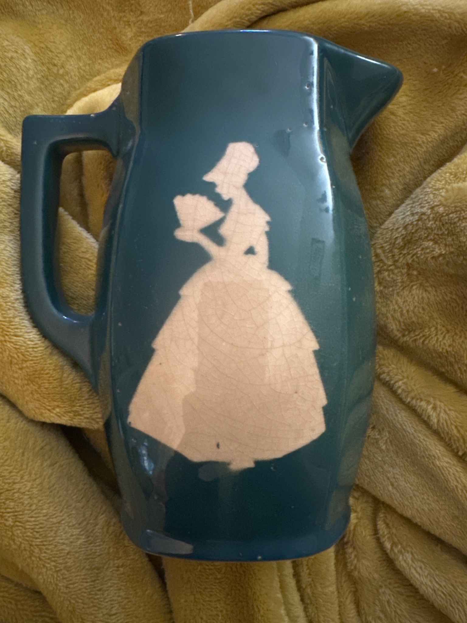 Art pottery pitcher or jug with silhouette decoration