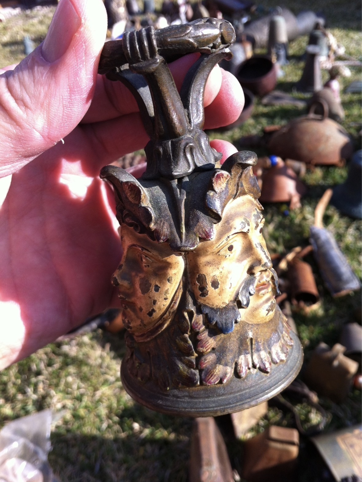 Cast metal decorative bell or small handbell with figural faces