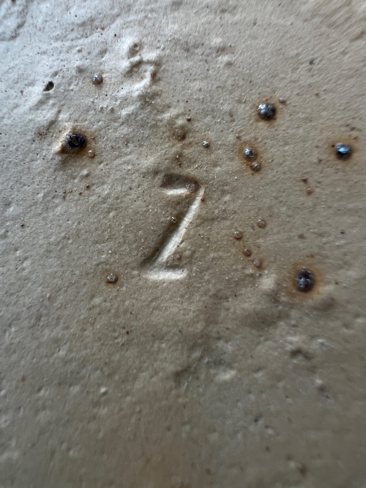 Stoneware or earthenware ceramic base with impressed numeral "2"