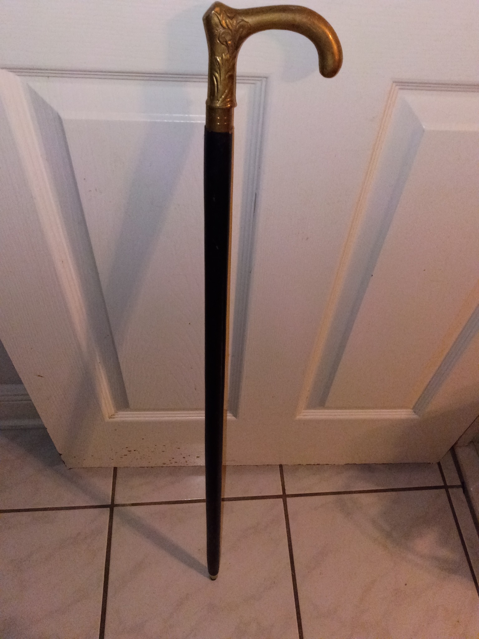 Victorian-style walking cane with ornate brass/gilt handle