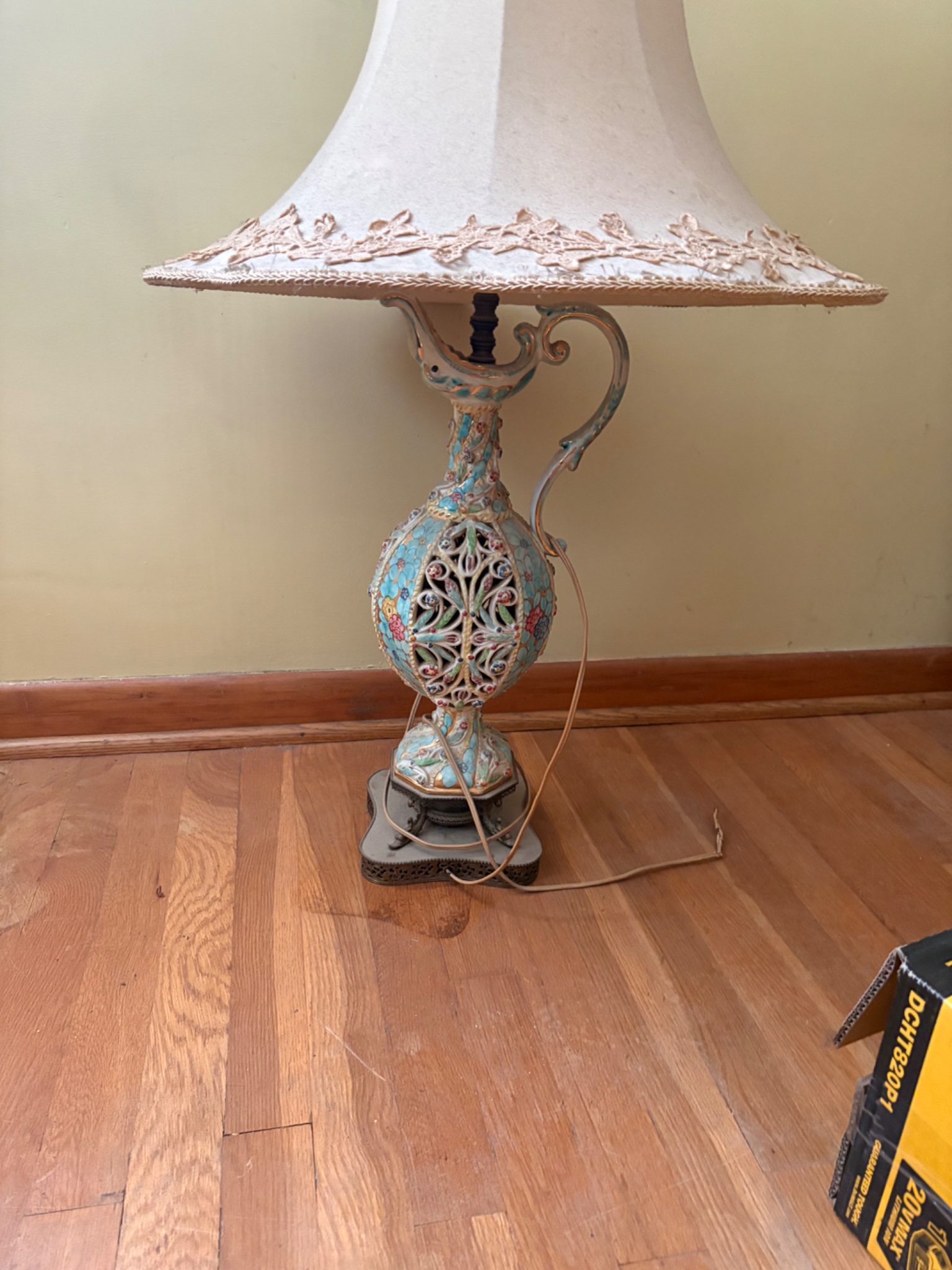 Decorative ceramic table lamp with pierced floral body and fabric shade