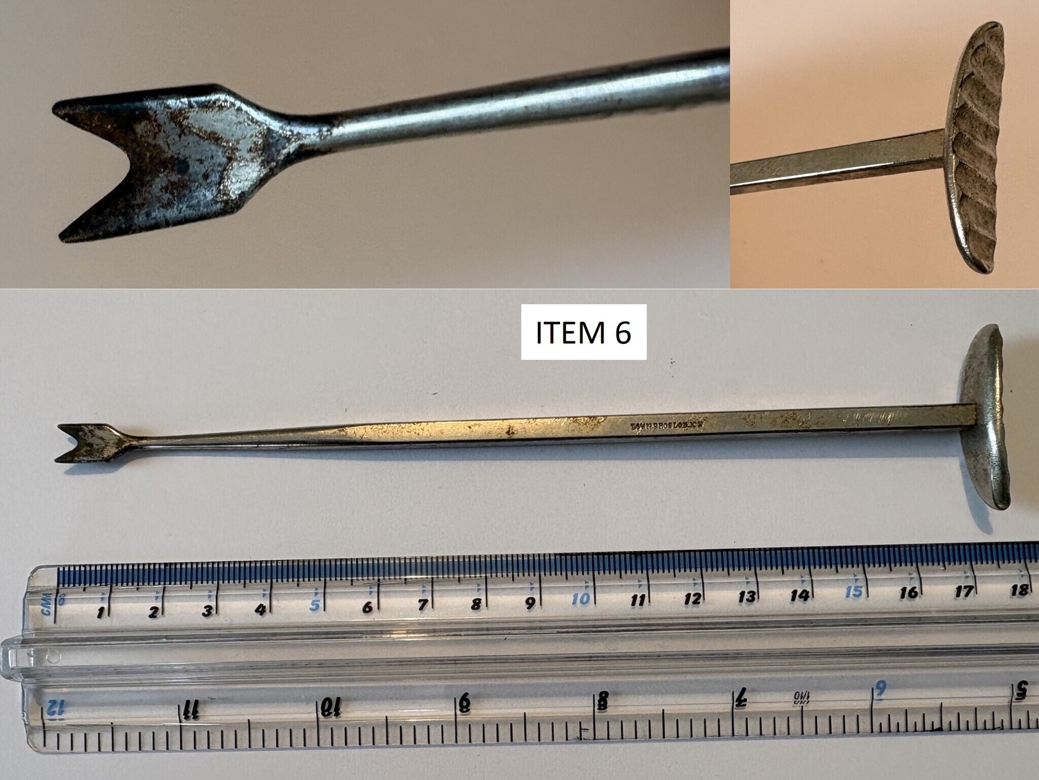Metal arrowhead-tipped rod, likely a tool or spear/implement shaft