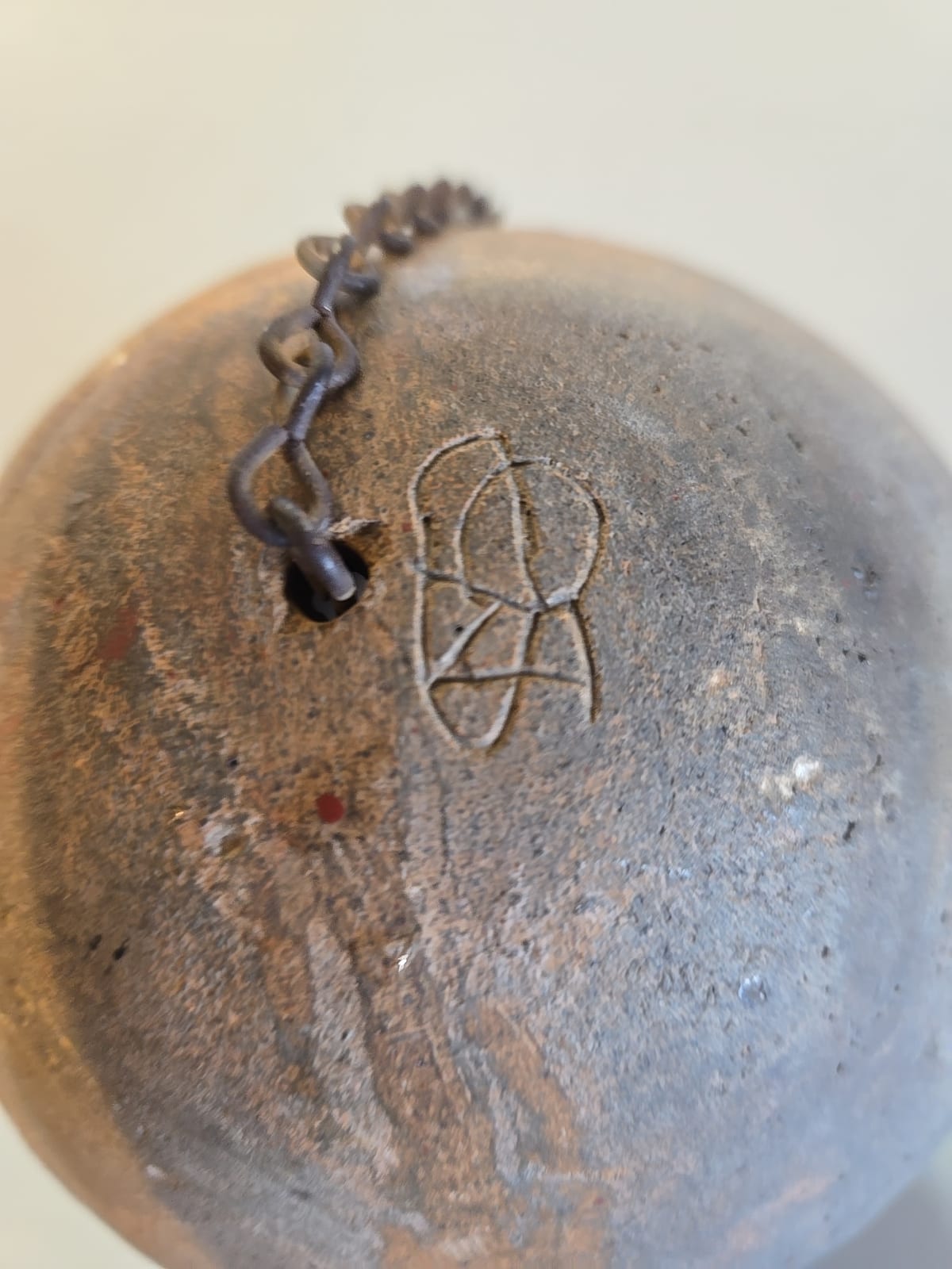 Hand-forged metal bell or weight with suspension chain