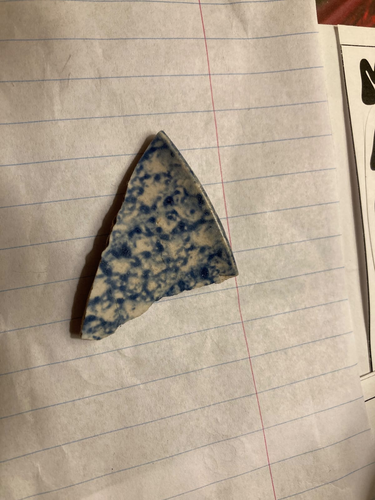 Blue-and-white speckled ceramic shard or fragment