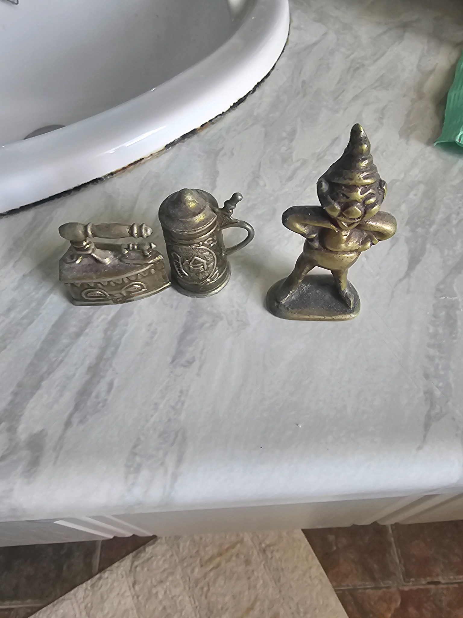 Assorted miniature brass novelty figurines and decorative trinkets