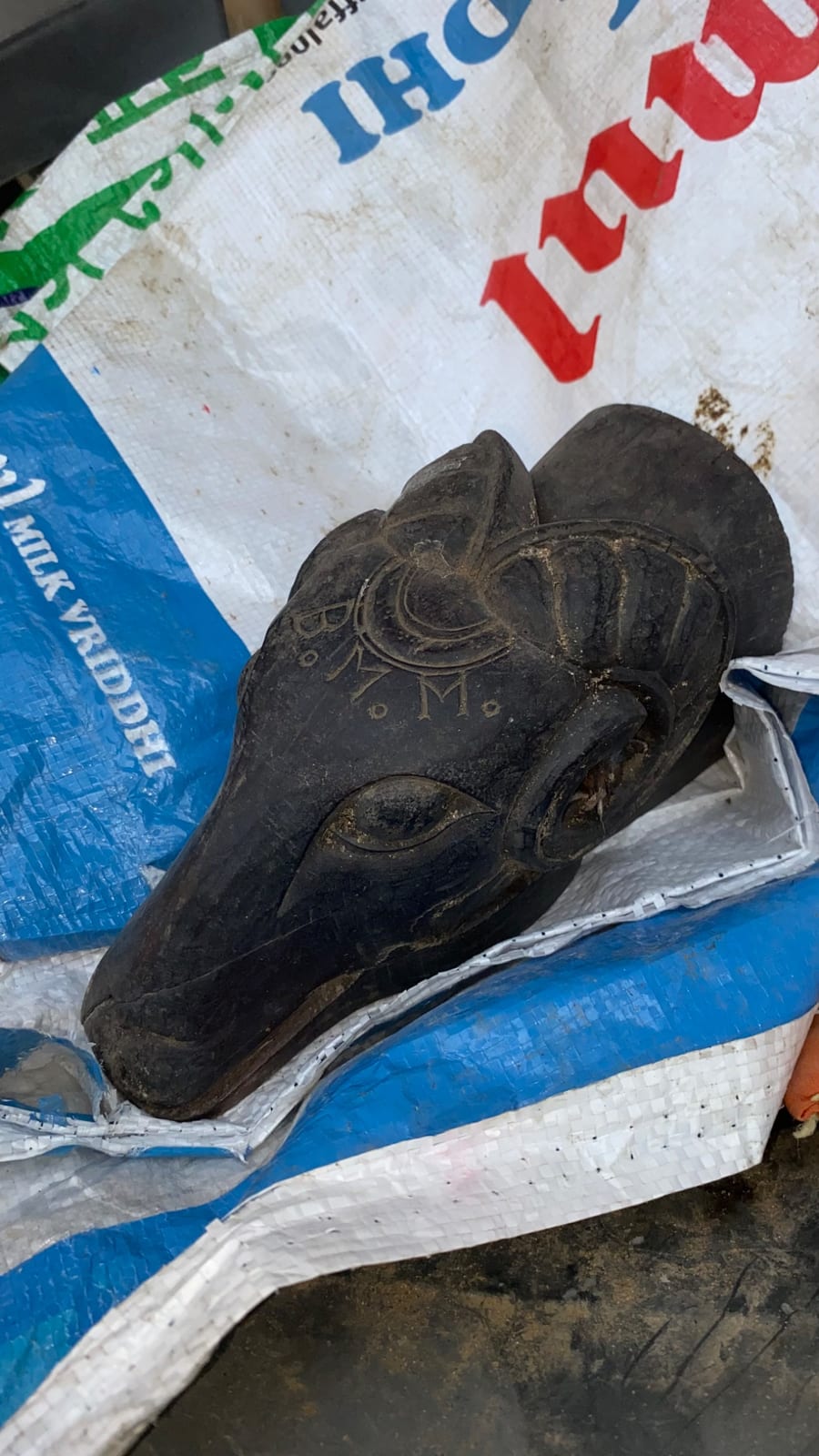 Carved wooden mask or head sculpture, likely African ceremonial or decorative