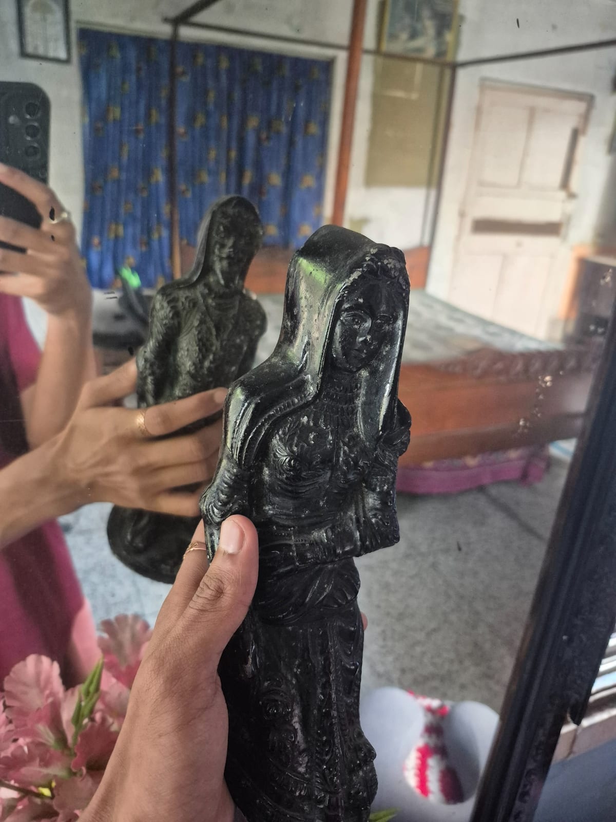 Carved black stone or resin female figurine, likely a decorative deity or muse figure