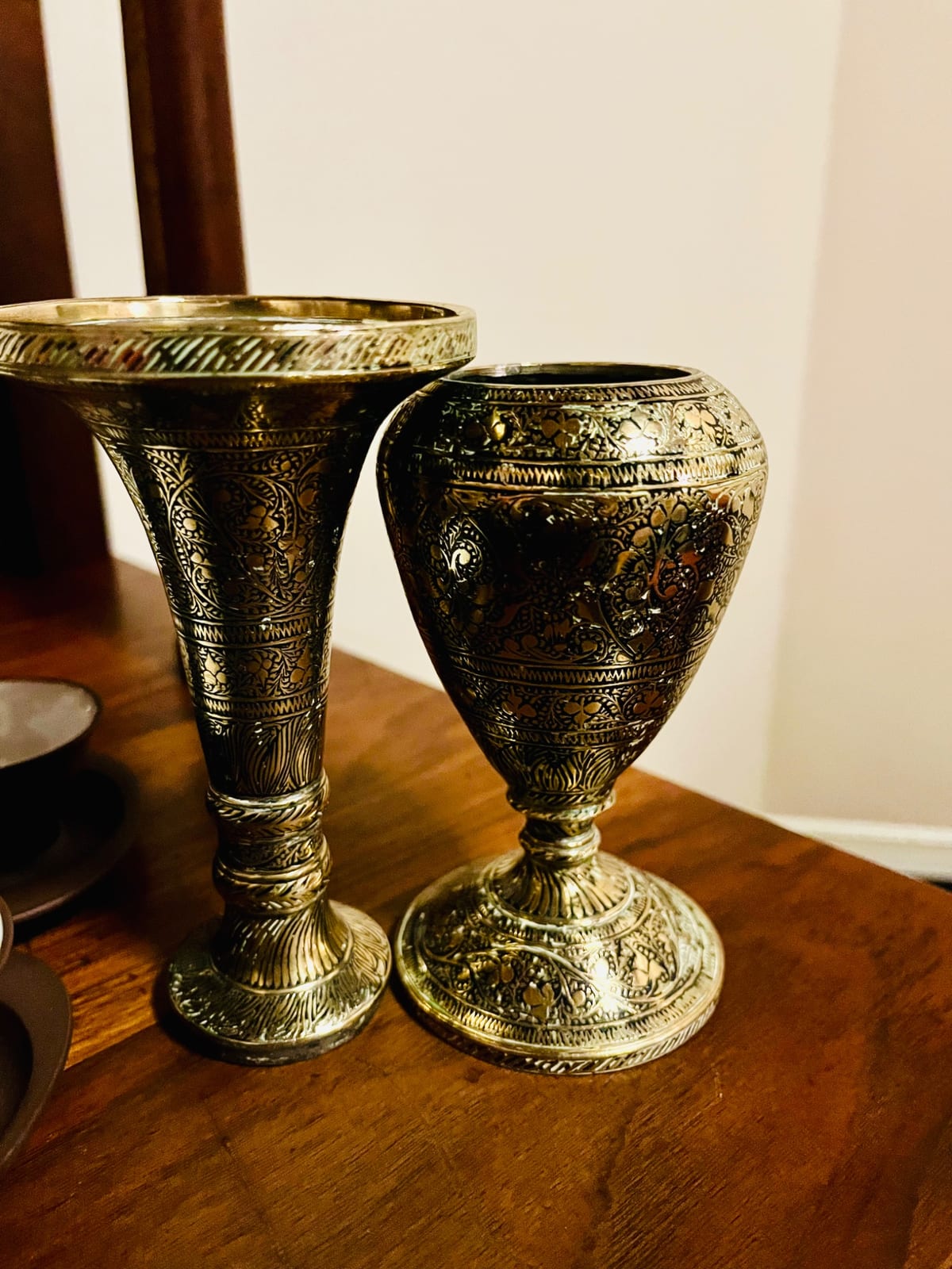Pair of ornate engraved metal goblets or chalices