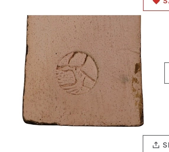 Ceramic or stoneware tile/brick fragment with impressed maker's mark