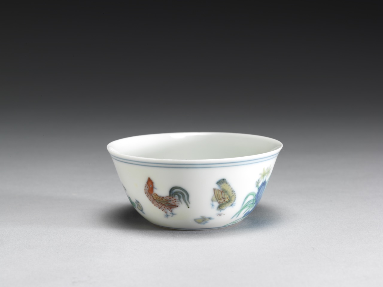 Small porcelain tea bowl or rice bowl with hand-painted rooster and floral decoration