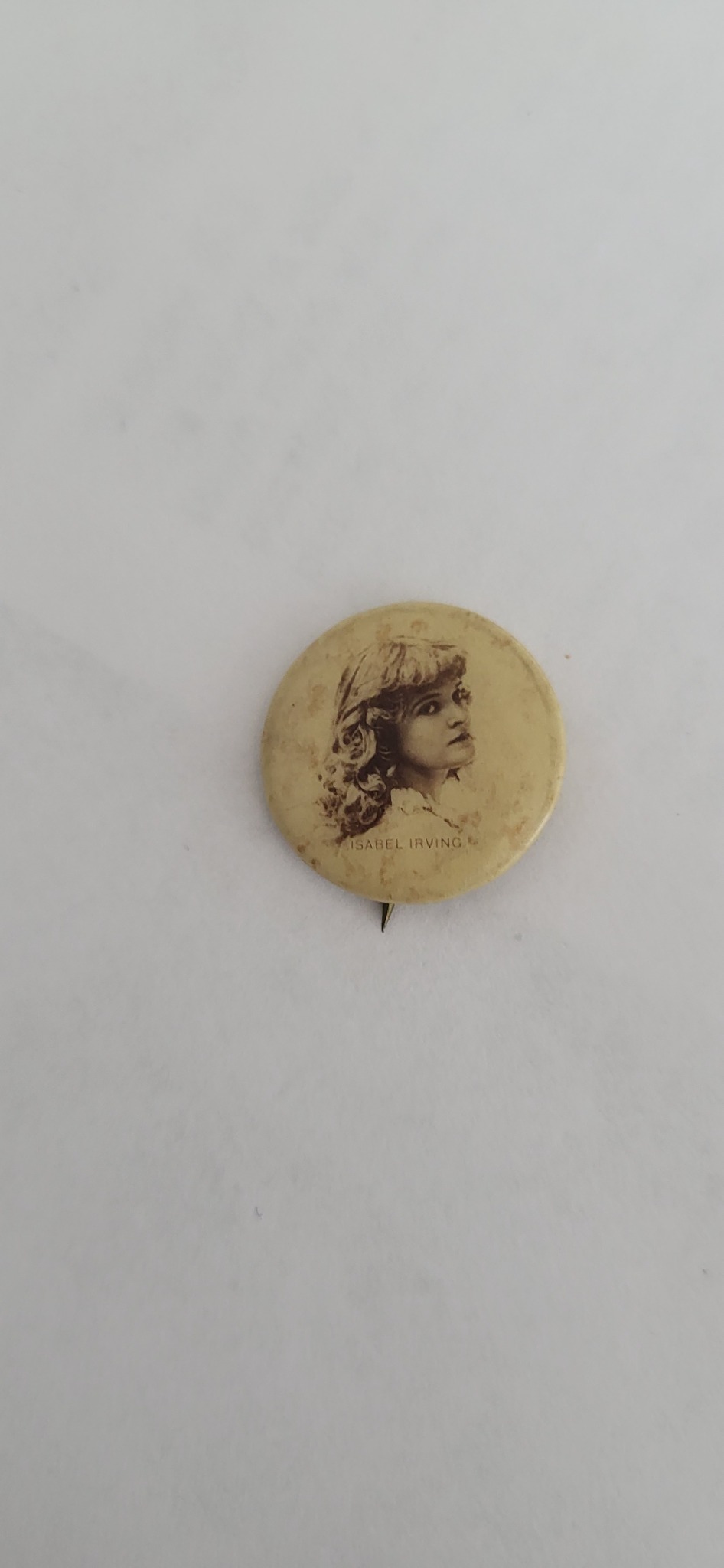 Victorian-era theatrical pinback button or celluloid promotional badge featuring Isabel Irving