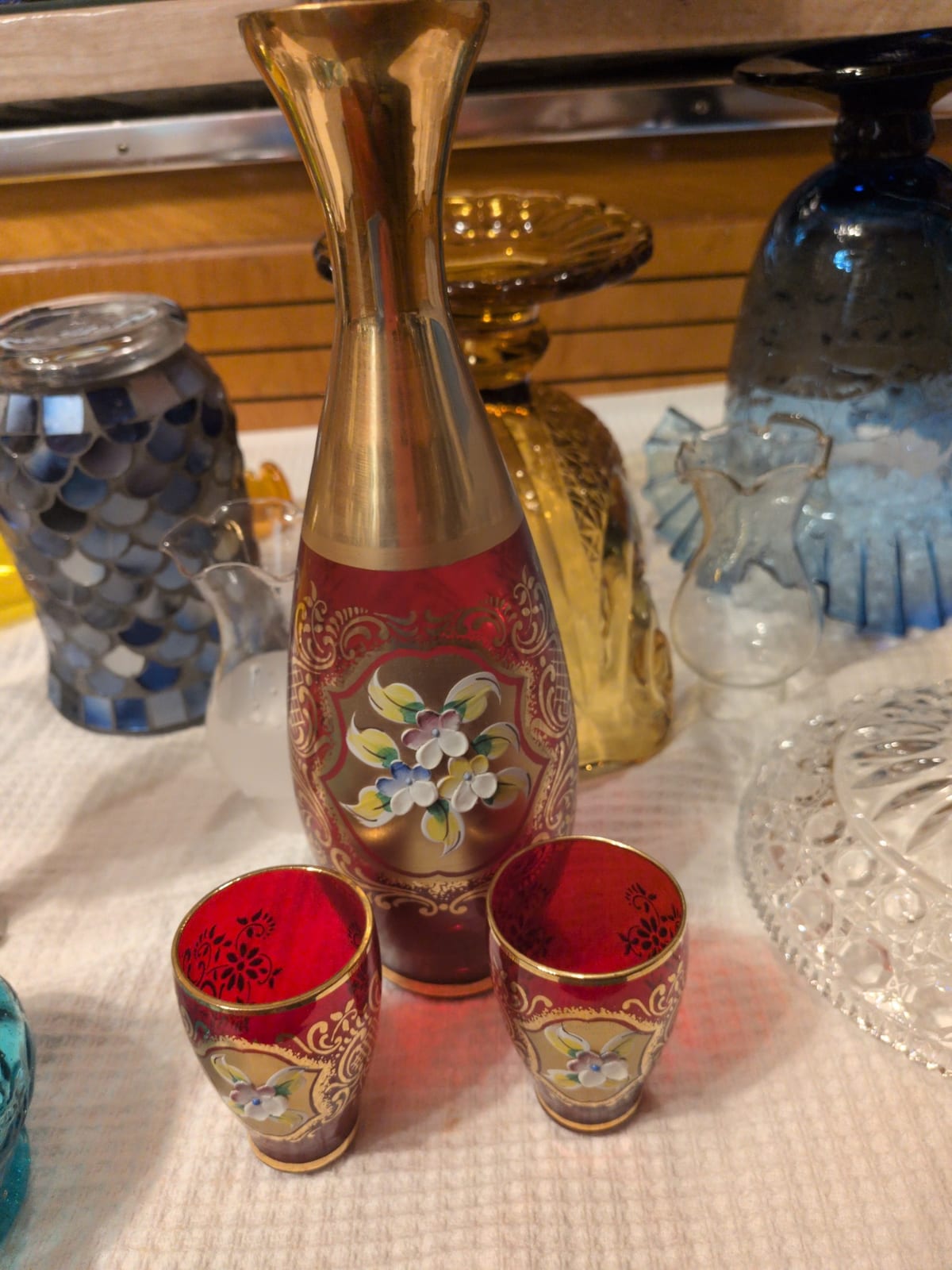Decorative enameled glass liquor decanter with matching shot glasses