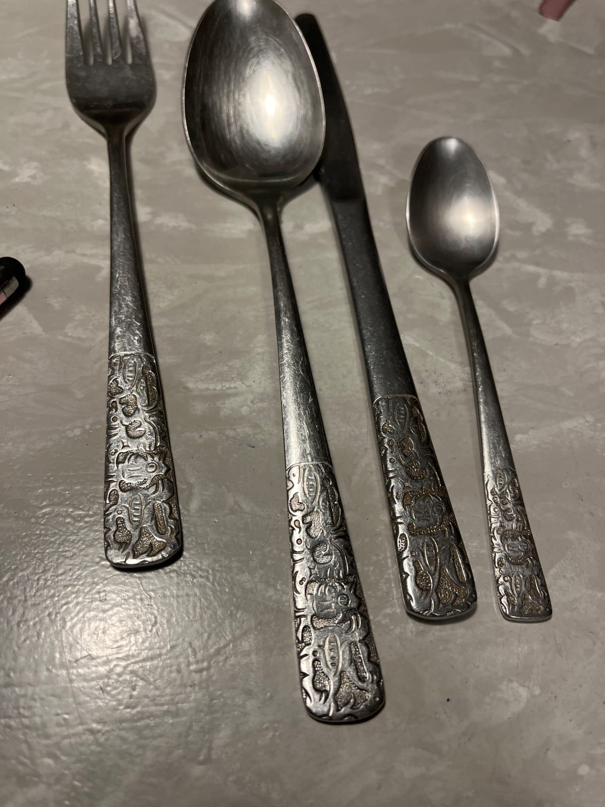 Set of decorative silver-plated flatware (fork, tablespoon, teaspoon, and knife)
