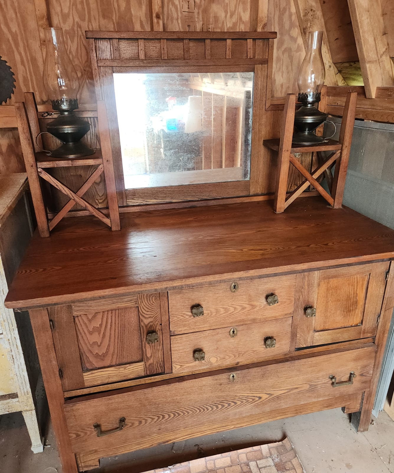 Mission-style oak dresser or sideboard with mirror back and oil lamps