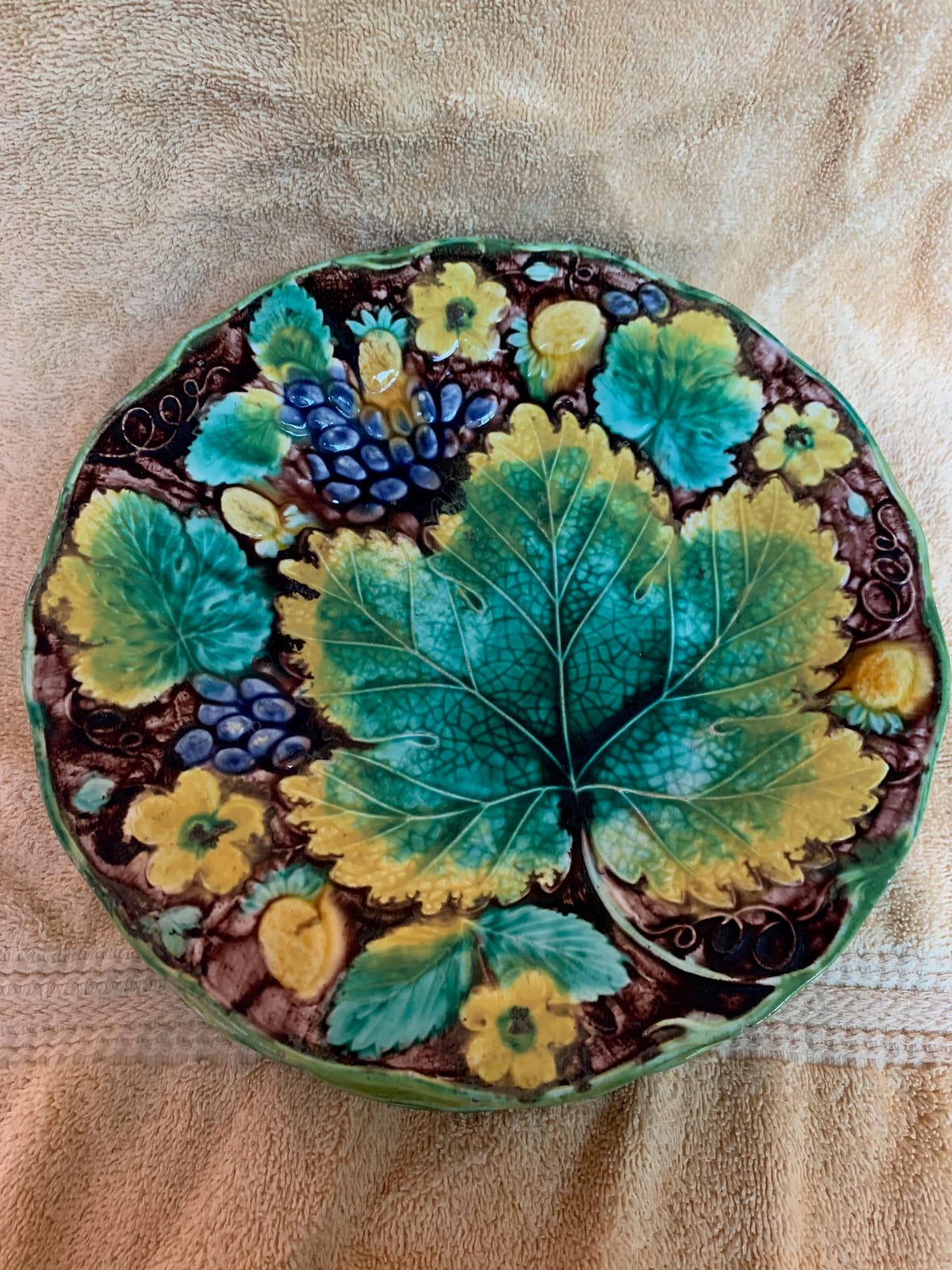 Majolica-style decorative ceramic plate or charger with grape and vine motif