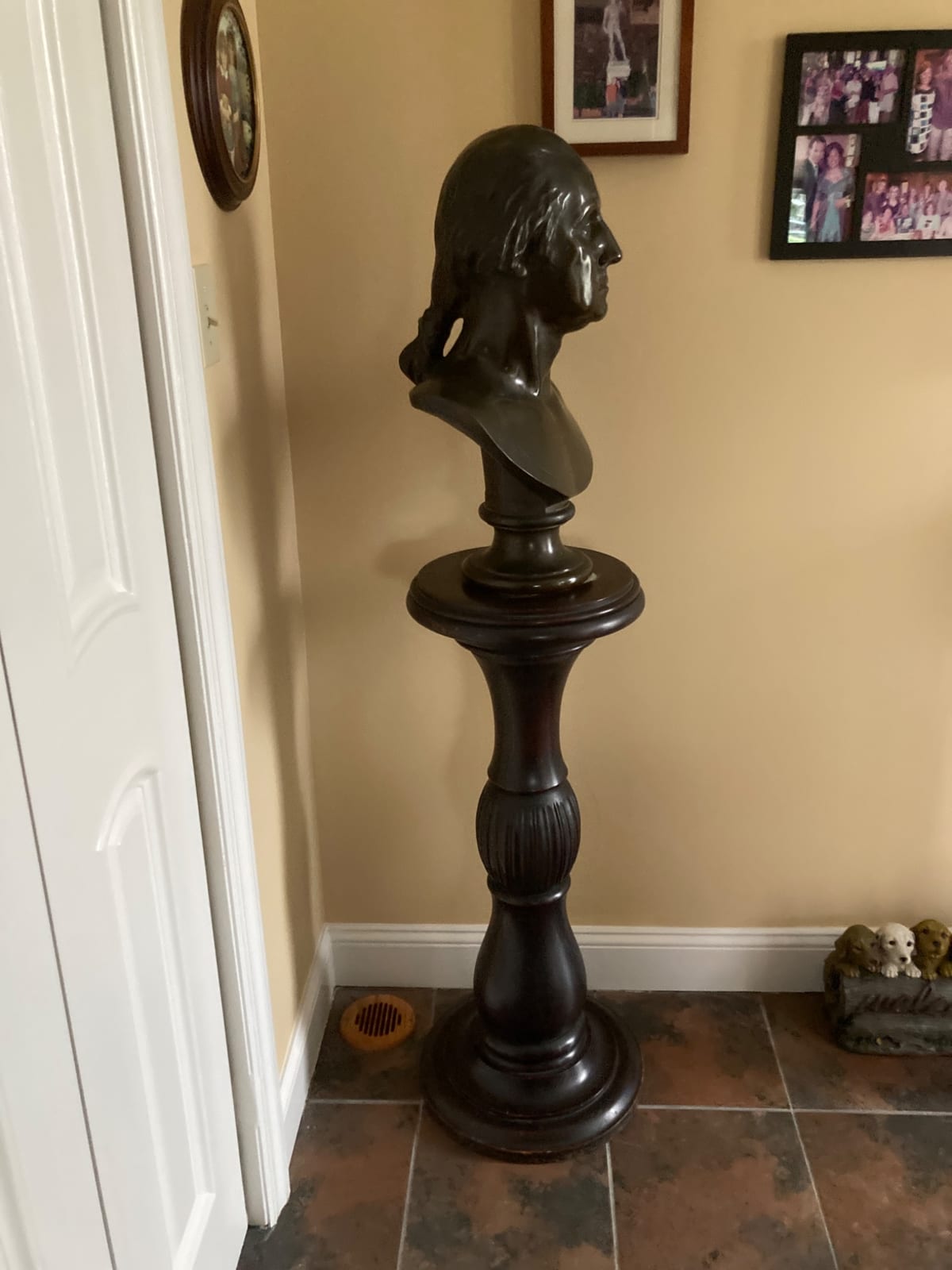 Neoclassical-style bust sculpture on pedestal