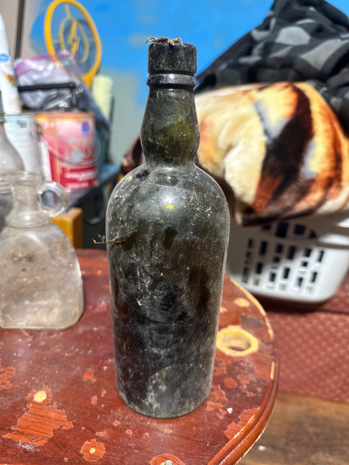 Antique dark glass bottle with applied lip and cork closure