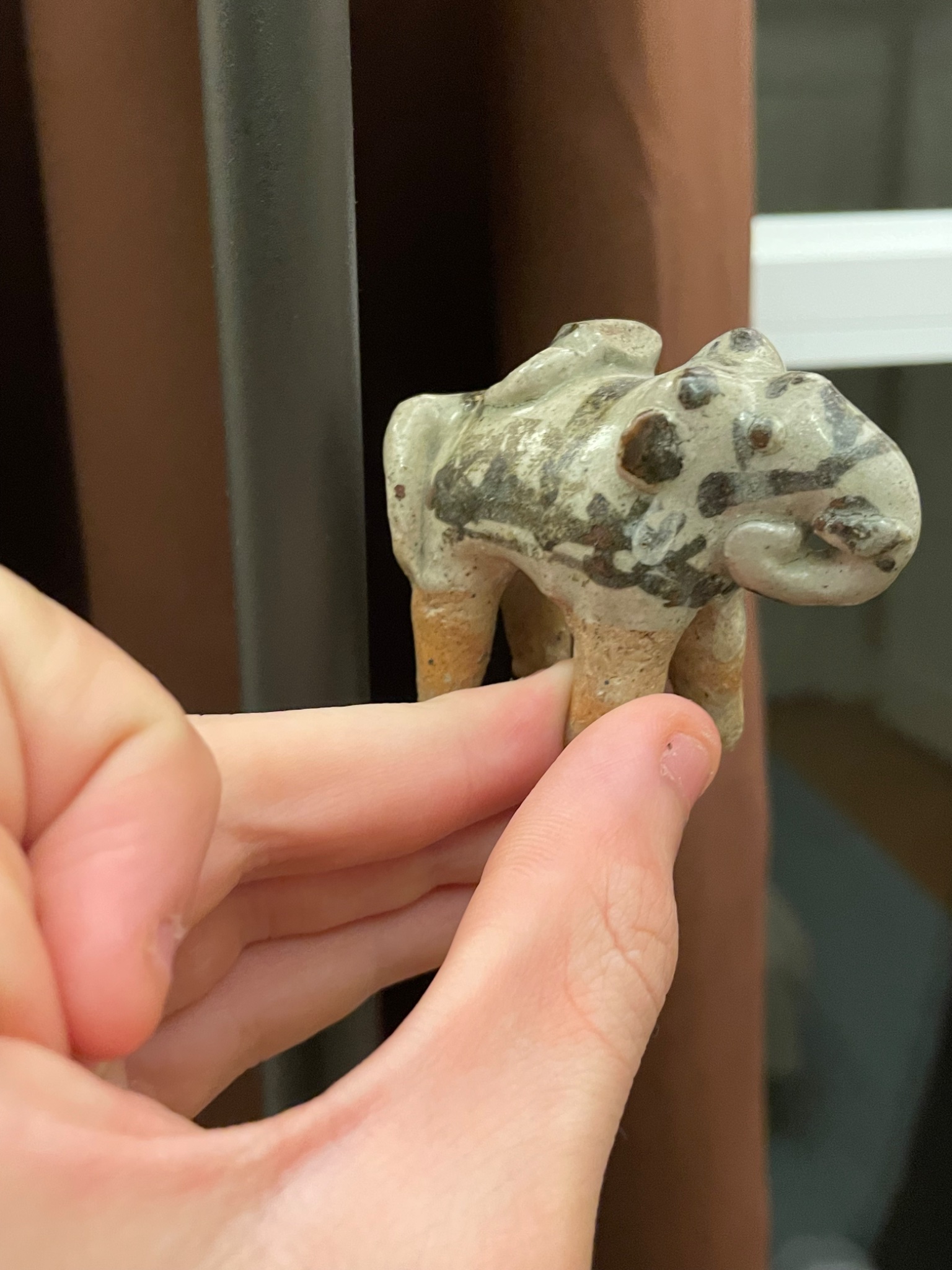 Small hand-modeled animal figurine (likely a pig or boar)