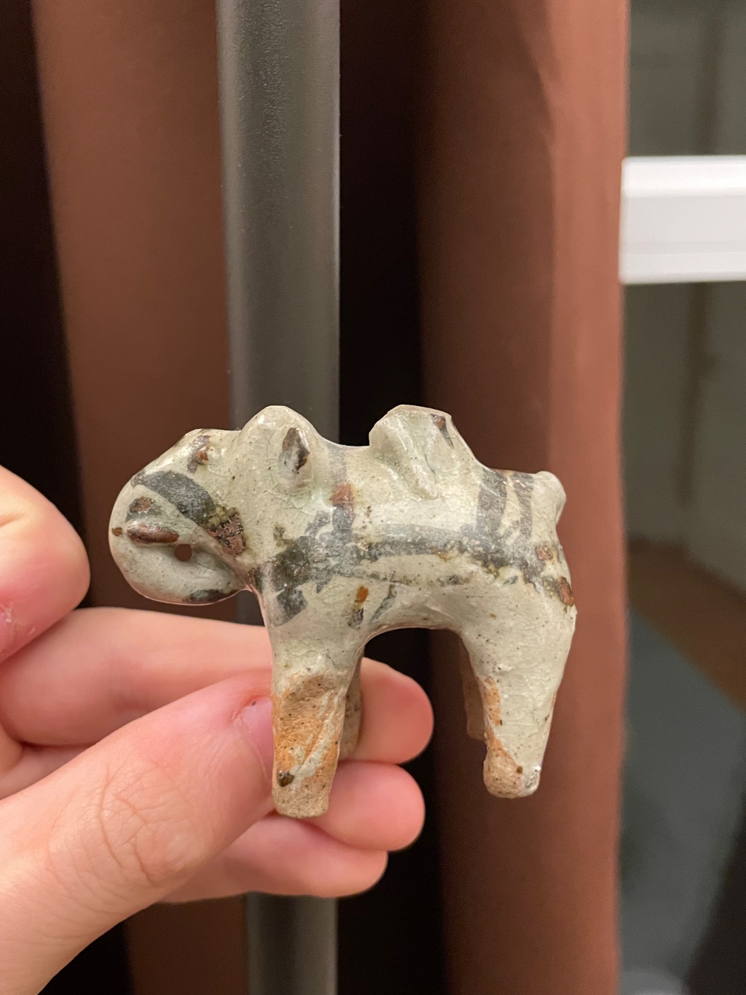 Small ceramic animal figurine (likely a camel or llama)