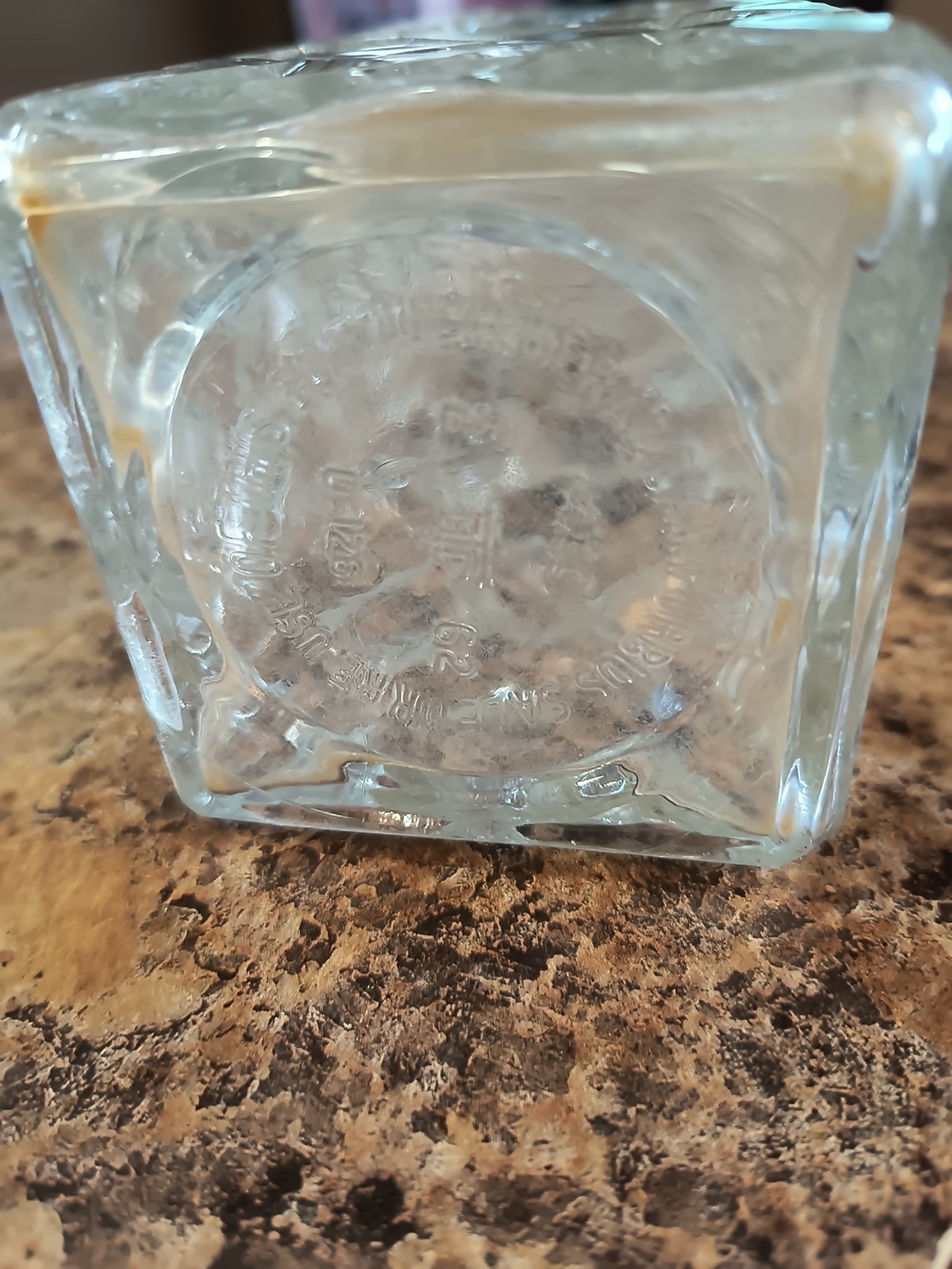 Embossed clear glass bottle or jar base