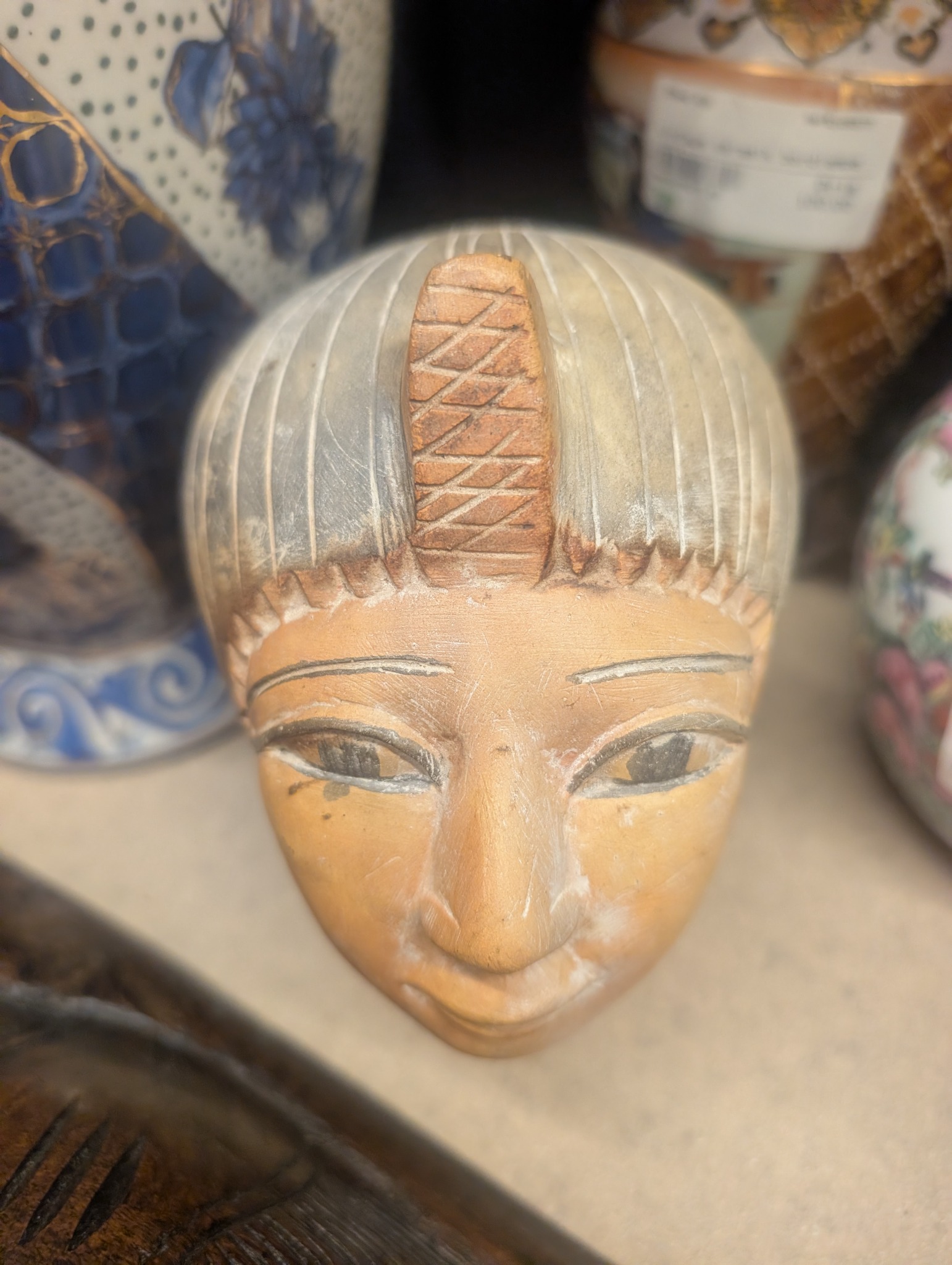 Carved and painted wooden female head mask or decorative wall mask