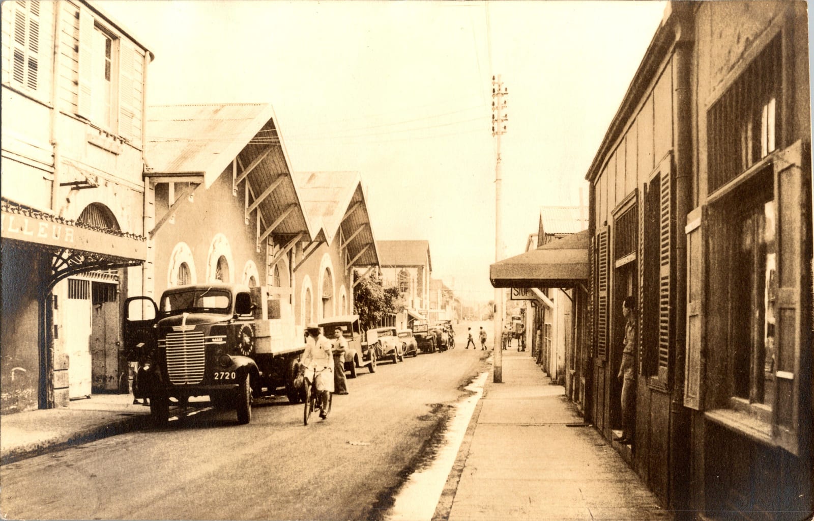 Vintage sepia-toned photographic print of a street scene