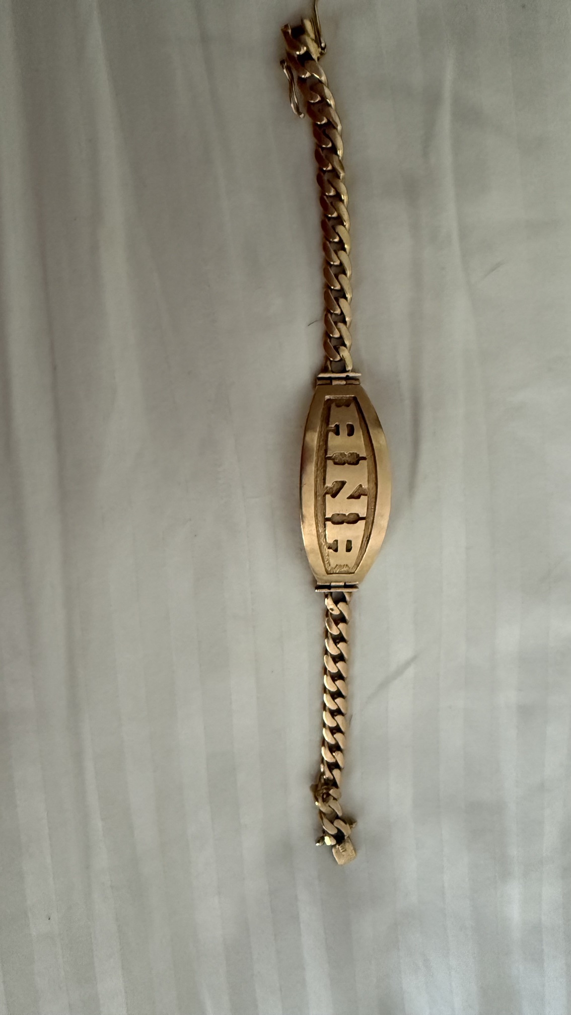 Gold-tone bracelet with oval monogram plaque