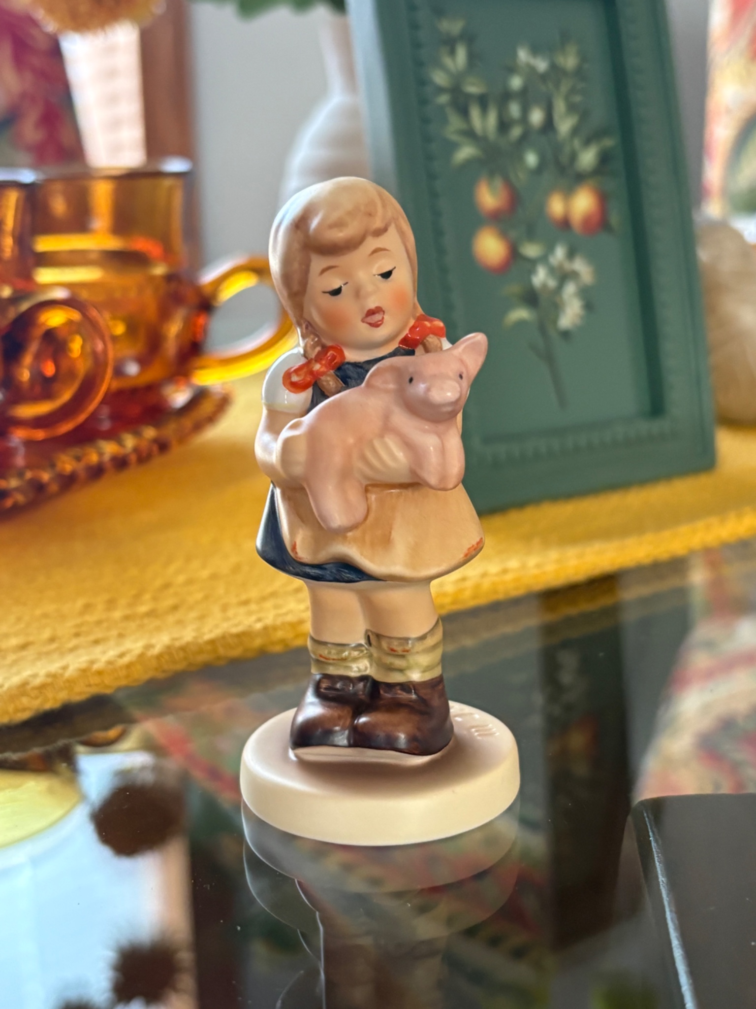 Ceramic figurine of a girl holding a piglet