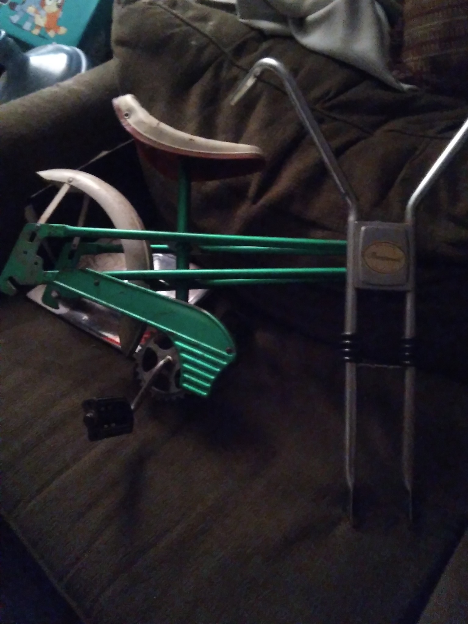 Vintage pedal-powered toy or child’s ride-on frame (possibly a tricycle/bicycle component or pedal car part)