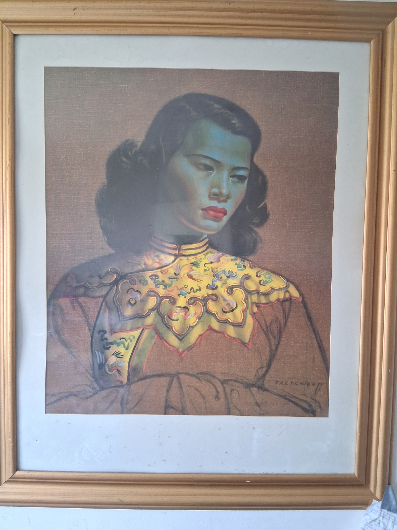Framed portrait print or painting of a woman in Chinese-inspired attire, signed "Tretchko"