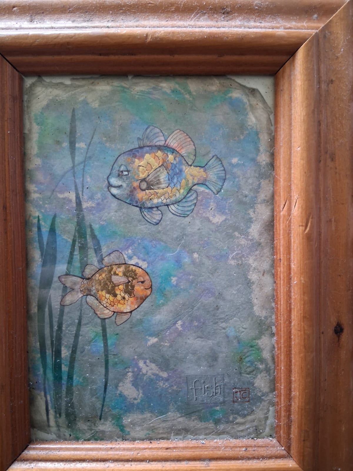 Framed decorative fish artwork with shell/mosaic inlay