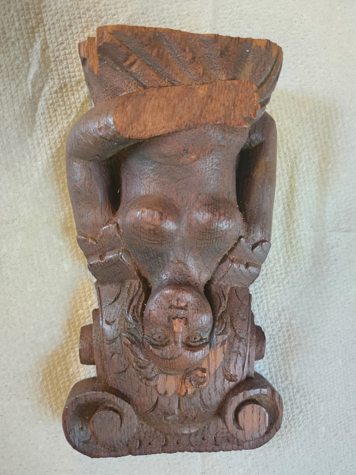 Carved wooden architectural bracket or decorative corbel with figural face