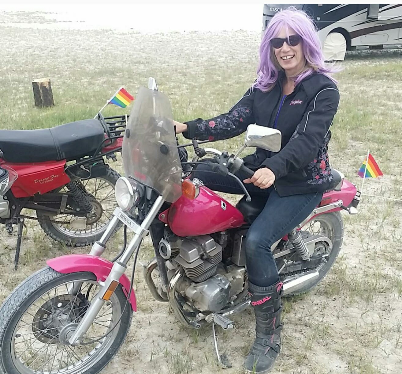Honda standard/naked motorcycle with custom pink paint and windshield