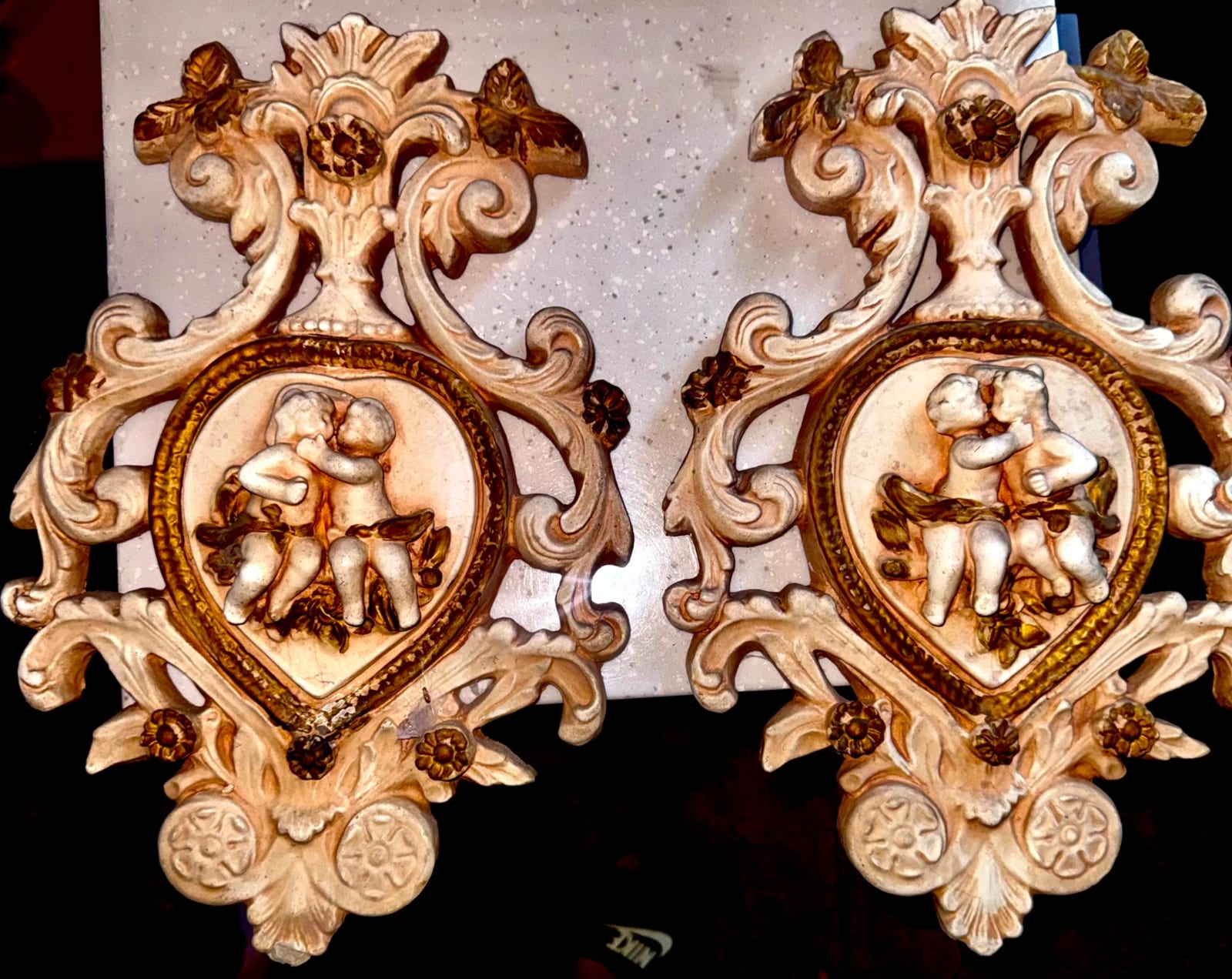 Pair of Rococo-style decorative wall appliqués or ornamental plaques with cherub reliefs