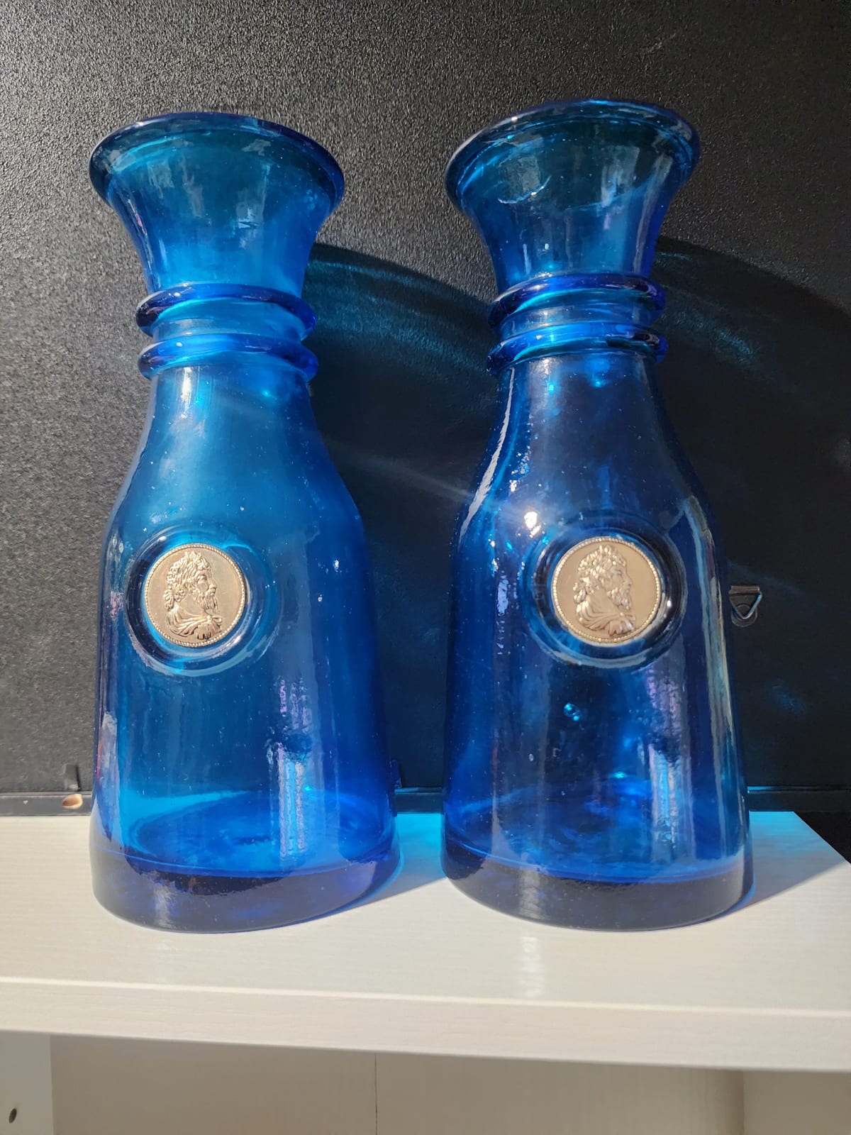 Pair of cobalt blue glass decorative vases or candlesticks with classical medallion inserts