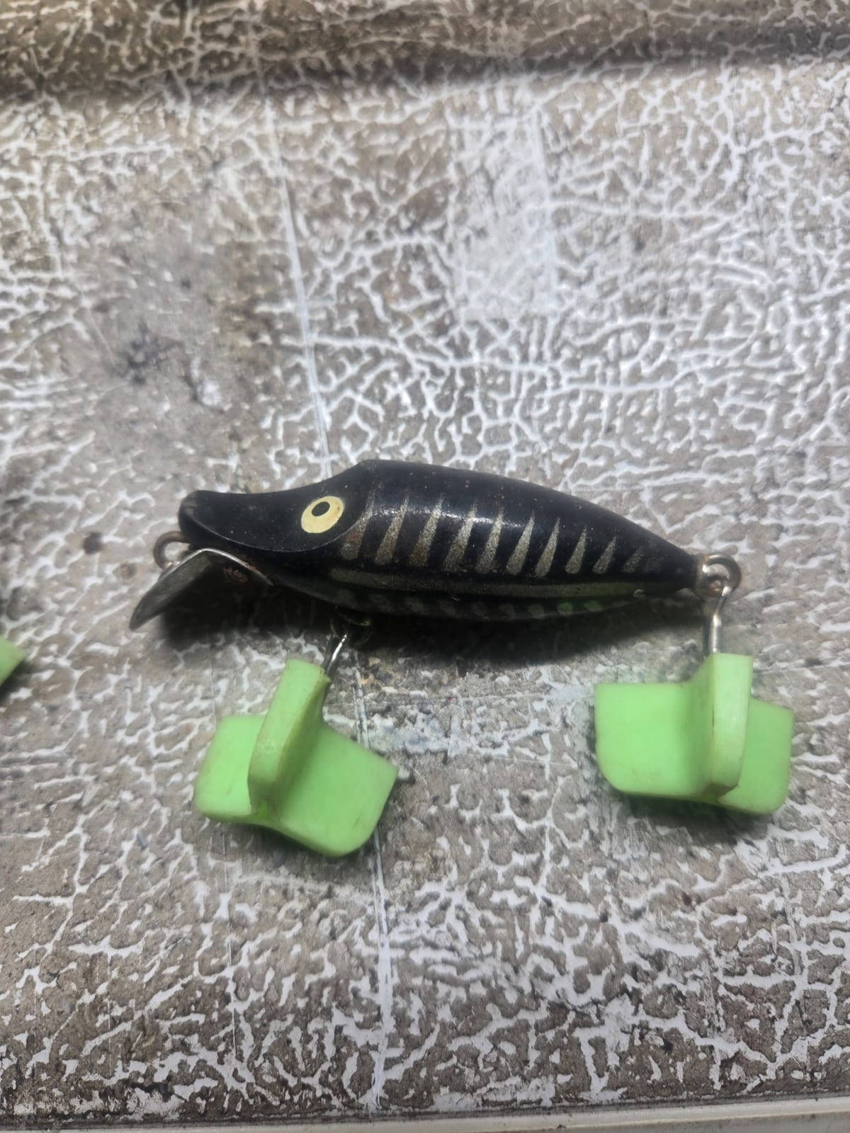 Vintage fishing lure (topwater plug with propeller and rubber tail fins)