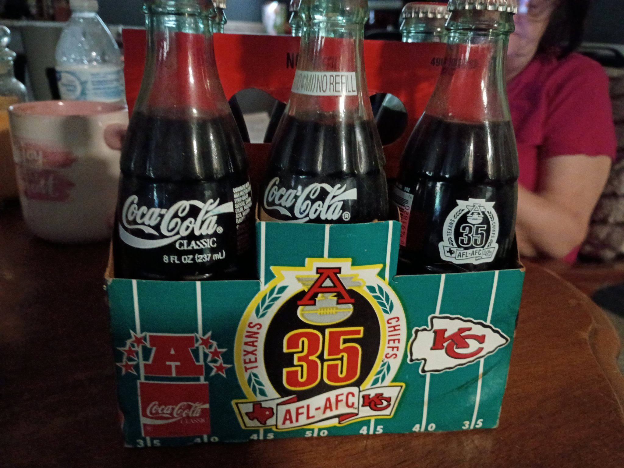 Coca-Cola commemorative six-pack carrier with Texas A&M / Kansas City Chiefs football-themed bottles